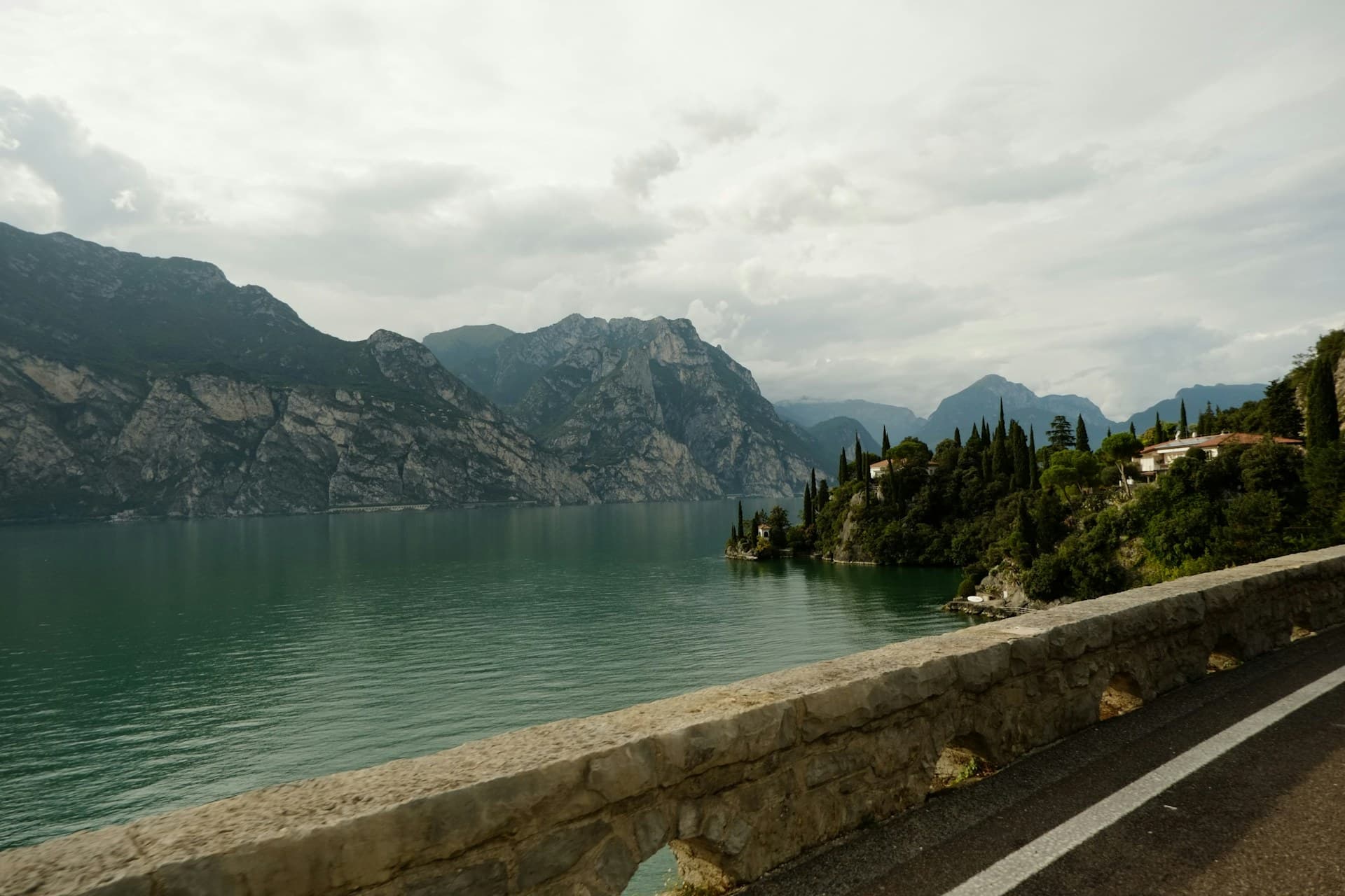 Road running alongside an Italian lake beneath the mountains